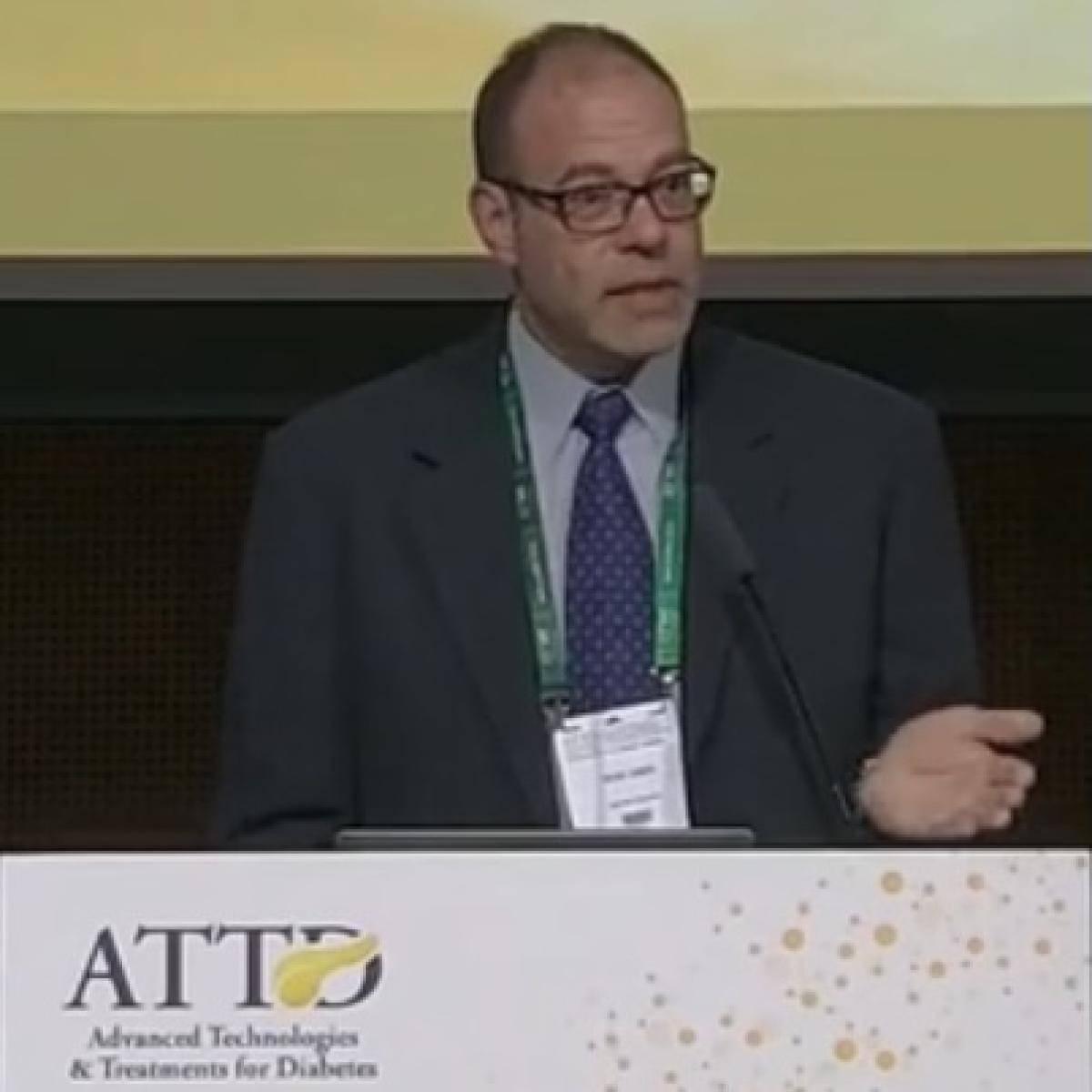 Dr. Sean Oser speaking at podium