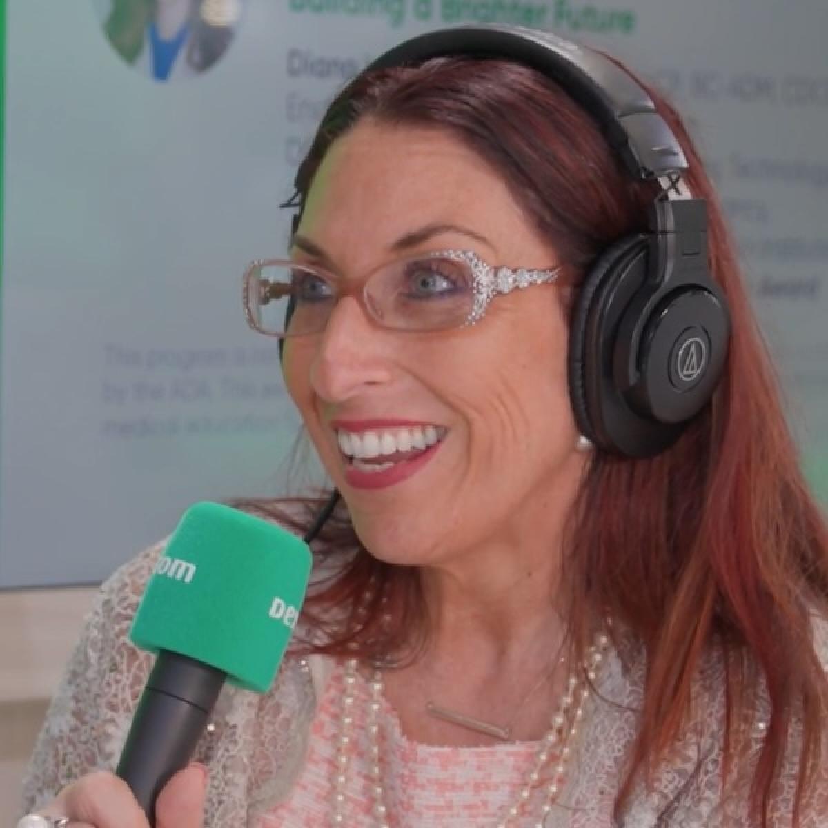 speaker holding green microphone