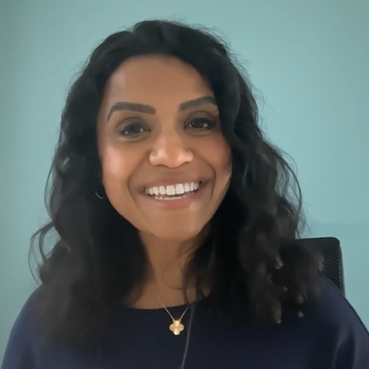 Dr.Anita Swamy in front of blue background