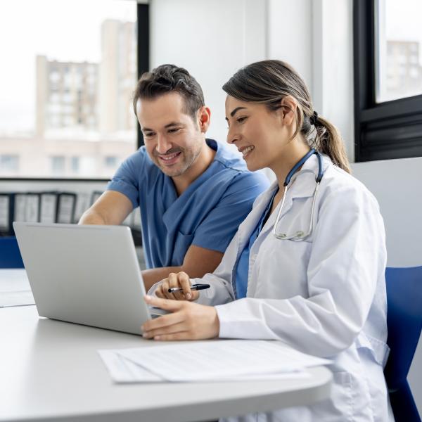 clinicians looking at laptop